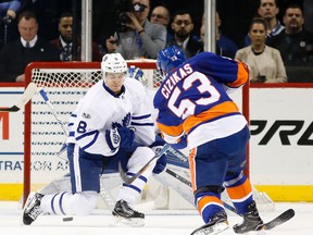 Maple Leafs defenceman Connor Carrick (left) defends in front of the Leafs' goal as Islanders centre Casey Cizikas (53) takes a shot during first period NHL action in Brooklyn, N.Y., on Monday, Feb. 6, 2017. (Kathy Willens/AP Photo)