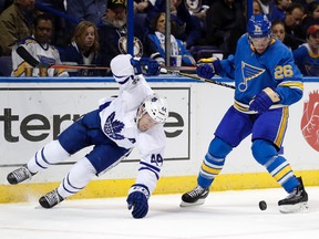 Leafs defenceman Morgan Rielly (left) is still feeling the pain from a nagging ankle sprain. (AP)