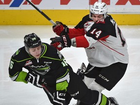 Edmonton Oil Kings' Davis Koch (left) gets hit by Prince George Cougars' Colby McAuley (right) during WHL action at Rogers Place in Edmonton on Jan. 29, 2017. (Ed Kaiser/Postmedia Network)