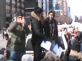 Black Lives Matter Toronto co-founder Yusra Khogali, right, speaks at a Feb. 4, 2017 protest outside the U.S. Consulate. (YOUTUBE)