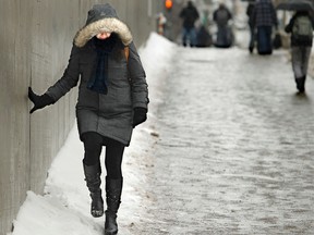 Walking on the sidewalk, or close to it, during winter weather.