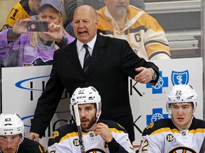 Boston Bruins head coach Claude Julien motions to an official during the first period of an NHL hockey game against the Pittsburgh Penguins in Pittsburgh, Sunday, Jan. 22, 2017. (AP Photo/Gene J. Puskar)