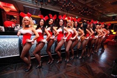 FILE - In this Dec. 18, 2010 file photo, waitresses pose inside the Playboy Club at the Sands Casino in Macau. The club closed in 2013. Three decades after the original Playboy Club closed in Manhattan, a new club will debut later this year in a hotel a few blocks from Times Square. (AP Photo/Kin Cheung, File)