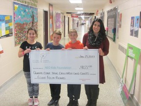 Taking part in a cheque presentation ceremony were Felix-Ricard students Emma, Christian and Sebastien along with Shanna from the NEO Kids Foundation. Supplied photo
