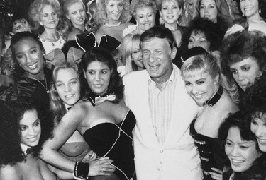 FILE - In this June 25, 1986 file photo, Playboy founder Hugh Hefner, center, poses with a group of current and former Playboy bunnies at the Playboy Club in Los Angeles, days before the club closed. The tightly corseted Playboy Bunnies, with rabbit tails and ears, will soon be back in business in New York City. Three decades after the original Playboy Club closed in Manhattan, a new club will debut later this year in a hotel a few blocks from Times Square. (AP Photo, File)