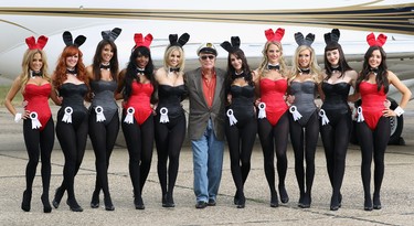 STANSTED, ENGLAND - JUNE 02:  Playboy founder Hugh Hefner (centre) arrives at Stansted Airport on June 2, 2011 in Stansted, England. The photograph is a recreation of a picture originally taken in the 1960's, with ten of the new London Bunnies. Mr Hefner is back in the UK to mark the launch of the new Playboy Club in Mayfair, which opens on June 4. The clubs opening will welcome back the iconic Playboy Bunny to Londonafter a 30 year absence. Famous Bunnies have included Debbie Harry and Lauren Hutton.  (Photo by Dan Kitwood/Getty Images)