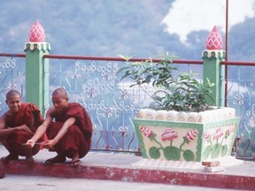 Monks talk outside a temple in 2005 in Yangon, Myanmar (Postmedia)
