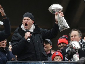 New England Patriots quarterback Tom Brady holds a Super Bowl trophy while addressing the crowd during a rally Tuesday, Feb. 7, 2017, in Boston. (AP Photo/Elise Amendola)