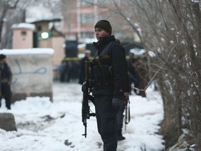 Security personnel stand guard at the site of a suicide attack on the Supreme Court in Kabul, Afghanistan on Feb. 7, 2017. (AP Photo/Rahmat Gul)