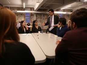 Attorney General Yasir Naqvi talks with participants of a town hall meeting about ticket sales in Ontario during a stop in Kingston on Tuesday. (Elliot Ferguson/The Whig-Standard)