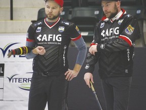 Skip Mike McEwen, left, and third B.J. Neufeld, right, discuss strategy ahead of the Viterra provincial curling championship in Portage la Prairie, Man., on Tuesday, Feb. 7, 2017. (Brian Oliver/The Graphic)