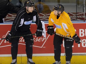 London Knights defence man Victor Mete, right, with defencman Evan Bouchard during practice at Budweiser Gardens on Tuesday. (MORRIS LAMONT, The London Free Press)