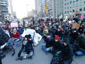 Protesters block University Avenue in front of the U.S. Consulate in Toronto against American President Donald Trump's executive order on immigration on Monday, Jan. 30, 2017. (MICHAEL PEAKE/TORONTO SUN)