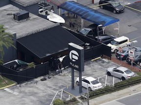 In this June 12, 2016 file photo, law enforcement officials work at the Pulse gay nightclub in Orlando, Fla., following the a mass shooting. (AP Photo/Chris O'Meara, File)