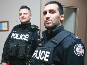 Toronto Police Consts. Paul Frias (left) and Amer Hussain responded to a bullet-riddled Brahms Ave. apartment in Toronto on Monday, Feb. 6, 2017. (VERONICA HENRI/TORONTO SUN)