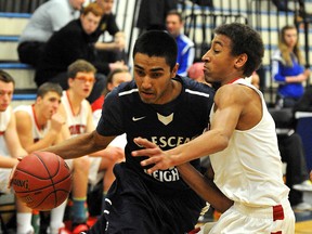Crescent Heights Cowboys' Navkirat Dhaliwal, left, is blocked by Raymond Comets Jaxon Davison during the 2011 Tri-Prov tournament at Harry Ainlay High School. This year's event begins Thursday, Feb. 9. (File)