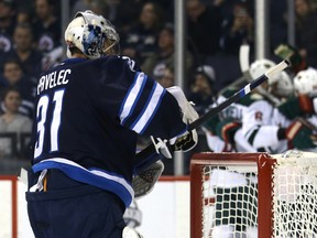 Jets goaltender Ondrej Pavelec resets as the Wild celebrate a goal from forward Jason Pominville during NHL action in Winnipeg on Tuesday, Feb. 7, 2017. (Kevin King/Winnipeg Sun)