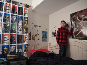 In this Dec. 13, 2016 file photo, Joe Maldonado, 8, stands in his room in Secauscus, N.J. Maldonado was asked to leave his scout troop last fall after parents and leaders found out he is transgender. The Boy Scouts of America announced Monday, Jan. 30, 2017, that enrollment in its boys-only programs will now be based on the gender a child or parent lists on his application to become a scout, rather than the gender listed on the child's birth certificate. But Maldonado's mother says she has mixed emotions about the organization's decision to allow transgender children who identify as boys to enroll in its boys-only programs. (Danielle Parhizkaran/Northjersey.com via AP, FIle)/The Record via AP)