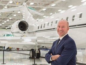 Bombardier President and CEO Alain Bellemare stands next to a Global 5000 aircraft Tuesday, February 7, 2017 in Montreal. The federal government says it will give Bombardier $372.5 million in repayable loans over four years to support the Global 7000 and CSeries aircraft projects. (THE CANADIAN PRESS/Paul Chiasson)