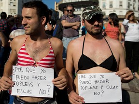 Men in bikini tops hold signs that read in Spanish "Why can I go topless and they can't" during a bare-breasted demonstration in Buenos Aires, Argentina, Tuesday, Feb. 7, 2017. People protested after police threatened several weeks ago to detain several women sunbathing topless on a beach in Argentina. (AP/PHOTO)