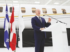 Bombardier CEO Alain Bellemare stands in front of a Global 7000 jet as he speaks during a press conference at Bombardier in Montreal on Feb. 7, 2017. (Allen McInnis/ MONTREAL GAZETTE)