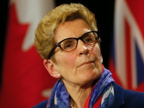 Ontario Premier Kathleen Wynne speaks to the media after her meeting with New Democratic Party leader Andrea Horwath and Conservative Party leader Patrick Brown at Queens Park in Toronto, April 11, 2016. (Stan Behal/Toronto Sun/Postmedia Network)