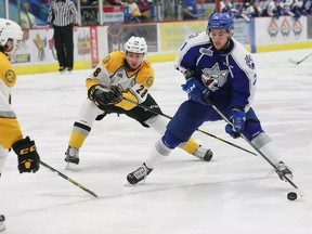 Kelton Hatcher, middle, of the Sarnia Sting, attempts to knock the puck away from David Levin, of the Sudbury Wolves, during OHL action at the Sudbury Community Arena in Sudbury, Ont. on Friday February 3, 2017. John Lappa/Sudbury Star/Postmedia Network