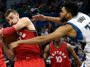 Raptors centre Jonas Valanciunas (left) rebounds against Timberwolves centre Karl-Anthony Towns during second quarter NBA action in Minneapolis on Wednesday, Feb. 8, 2017. (Hannah Foslien/AP Photo)