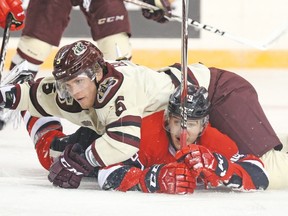 Alex Black of the Peterborough Petes smothers 67’s Travis Barron during last night’s game at The Arena at TD Place. Despite a terrific effort, the 67’s were still outgunned 3-1. (Jean Levac, Postmedia)