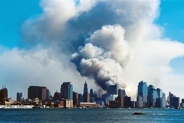 As seen from New Jersey, smoke hangs over South Manhattan after the collapse of the twin towers of the World Trade Center in a terrorist attack, New York, New York, September 11, 2001.