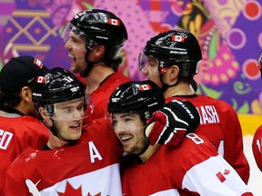 Team Canada's Drew Doughty (#8) celebrates his overtime winning goal with Team Canada's Jonathan Toews and other players at the end of their men's ice hockey game against Team Finland at the Bolshoy Ice Dome during the Sochi 2014 Winter Olympics in Sochi, Russia, on Sunday Feb. 16, 2014. Al Charest/Calgary Sun