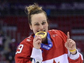 Canada’s Marie-Philip Poulin celebrates with her gold medal during the 2014 Sochi Winter Olympics at the Bolshoi Ice Dome on Feb. 20, 2014. (Jonathan Nackstrand/Getty Images)