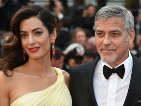 US actor George Clooney (R) and his wife, British-Lebanese lawyer Amal Clooney pose on May 12, 2016 as they arrive for the screening of the film 'Money Monster' at the 69th Cannes Film Festival in Cannes, southern France. (ALBERTO PIZZOLI/AFP/Getty Images)