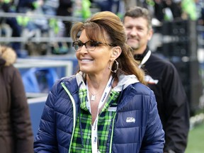 In this Dec. 15, 2016 file photo, Sarah Palin, political commentator and former governor of Alaska, walks on the sideline before an NFL football game between the Seattle Seahawks and the Los Angeles Rams, in Seattle. (AP Photo/Scott Eklund, File)