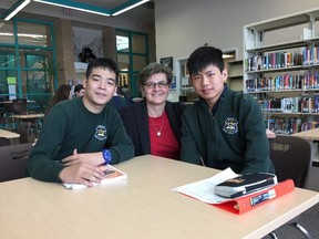 Students Khoa Pham (left) and Yuliang Lu are pictured with teacher Monica Dailey at St. Benedict Catholic Secondary School. Photo supplied