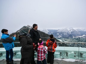 The Al Omare family looks out at Banff, Alta., from the Banff Gondola's rooftop observation deck, Feb. 3, 2017. The family are Syrian refugees who now live in Calgary. (Daniel Katz/ Crag & Canyon/ Postmedia)