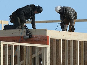 Tradespeople work on new housing construction on Templeton Avenue in north Winnipeg on Thu., Feb. 9, 2017. (Kevin King/Winnipeg Sun/Postmedia Network)