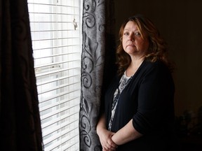 Brenda Hill survived a gunshot to the back while sleeping in her home in west Edmonton in Dec 2015. She posed for a photo near where the bullet penetrated the wall and struck her in her bed on Thursday, February 9, 2017.