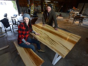Jay Aristone and Heather Torraville show a wood table they built in their south London workshop from trees cut down by the City of London. The two, partners in a small business called Rustix Furniture and Design, get logs delivered through the city?s log-drop program. (MORRIS LAMONT, The London Free Press)