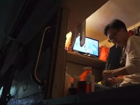 Simon Wong, of Hong Kong, lives in a 1.9 square-metre coffin home. He's been living there for 20 years. (Screengrab)