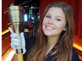 Belleville native and Bayside S.S. grad, Brianna Christopher, with an Olympic torch at Canada's Sports Hall of Fame in Calgary where she is doing an internship through Durham College. (Submitted photo)