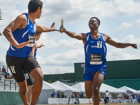 Yassine Aber receives from Dustie Joseph in the mens 4x400 metre relays at the Canadian Track and Field champions in Edmonton. July 5, 2015. (Bruce Edwards / Postmedia Network)