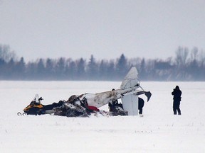 Transport Safety Board and RCMP investigators work at the scene of a fatal plane crash 11km outside of Brunkild, Man., on Friday, February 10, 2017. Two men were killed in the crash. THE CANADIAN PRESS/John Woods