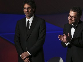 Ethan Coen, right, and Joel Coen standing on stage during the opening ceremony at the 68th international film festival, Cannes, southern France. (Joel Ryan/Invision/AP)