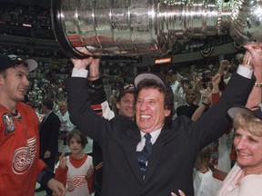 In this June 17. 1998, file photo, Detroit Red Wings owner Mike Ilitch, center, hoists the Stanley Cup in Washington after the Red Wings won their second consecutive NHL championship. (Julian H. Gonzalez/Detroit Free Press via AP)