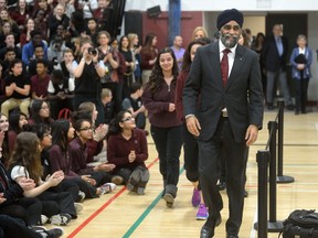 Defence Minister Harjit Sajjan arrives in the gym at John Paul II Catholic secondary school in London Friday to answer questions from students. Sajjan also announced his government would upgrade 141 more light armoured vehicles in a deal worth $404 million to General Dynamics Land Systems Canada. (MORRIS LAMONT, The London Free Press)