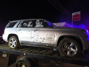 A bullet ridden sports utility vehicle is taken away by authorities after a gun battle with marines in which a man identified by authorities as the leader of the Beltran Leyva drug cartel, Juan Francisco Patron Sanchez, and several of his accomplices died during the exchange of gunfire in Tepic, Nayarit state, Mexico, early Friday, Feb. 10, 2017. During the battle, marines poured gunfire into a house from a helicopter-mounted machine gun. (AP Photo/Chris Arias)