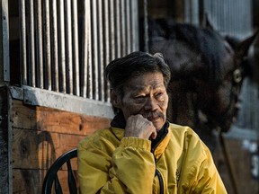 Groom Pauly Suksiri — seen here posing recently in the horse stables at Tomiko Training Centre near Campbellville, Ont. — passed away on Monday after a battle with cancer at Milton District Hospital. (Craig Robertson/Toronto Sun)