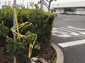 Police crime scene tape is left behind after an investigation into the death of 27-year-old Trisha Verdugo of Orange who was hit by a car Thursday night in the strip-mall parking lot in Santa Ana, Calif., Friday, Feb. 10, 2017. (Ken Steinhardt/The Orange County Register via AP)