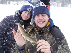 Sudbury Wolves defenceman Patrick Sanvido shows off his catch with George Matsos while ice fishing on Red Deer Lake in Sudbury on Sunday. Gino Donato/Sudbury Star